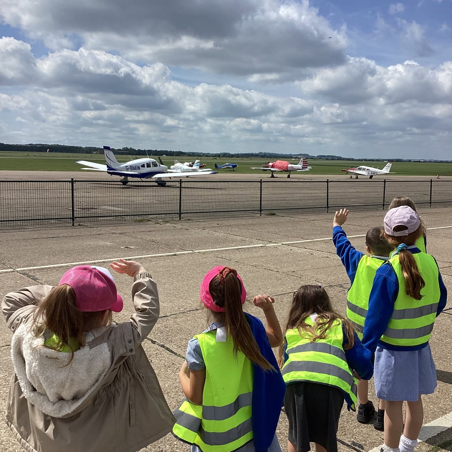 Pupils from Woolpit Primary Academy at an airfield with light aircraft