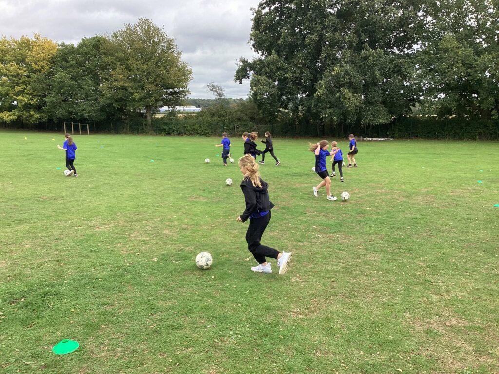 Woolpit Primary Academy girls playing football
